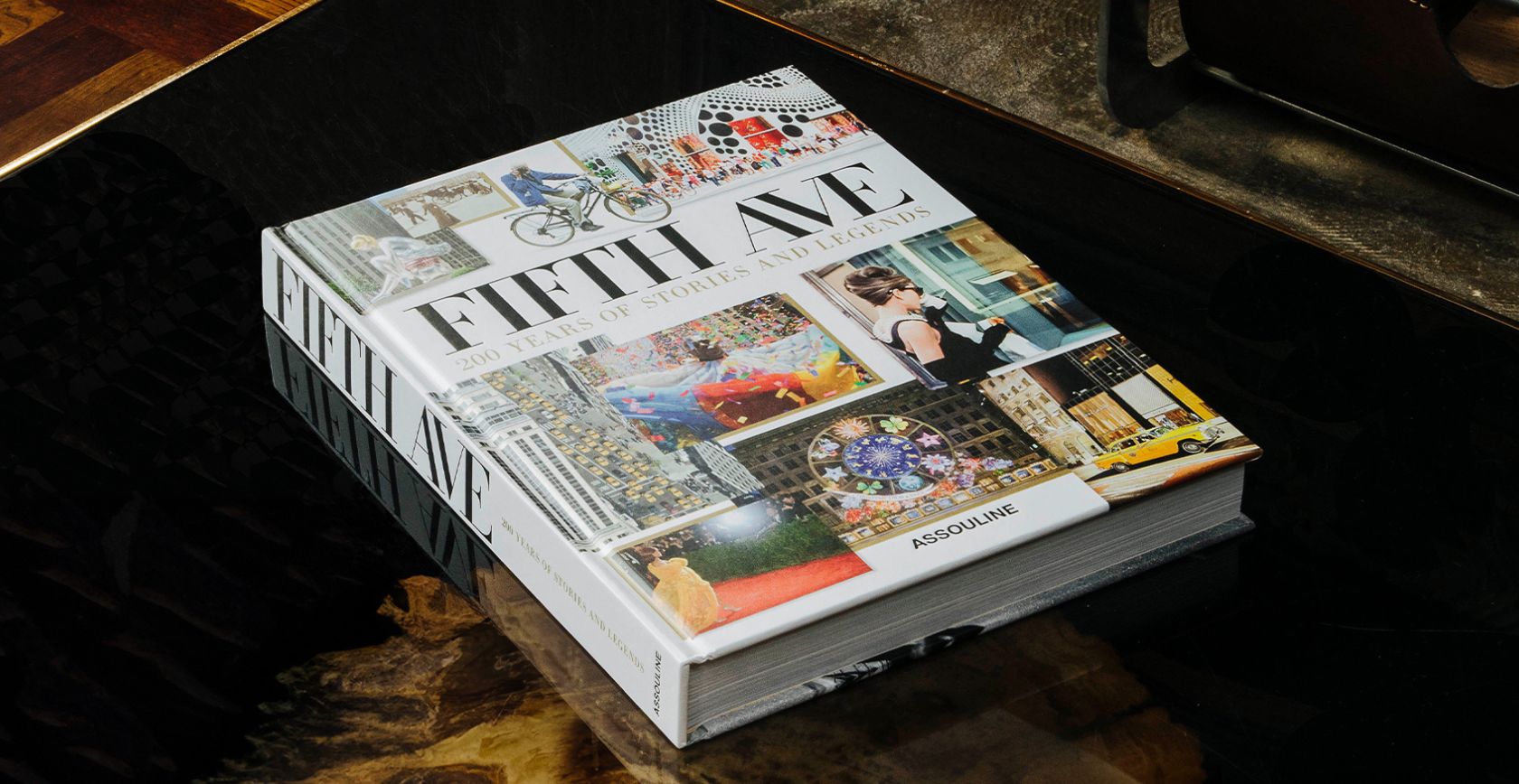 Assouline - New Arrivals 5th ave. New york book, collage of images on white background, book on table